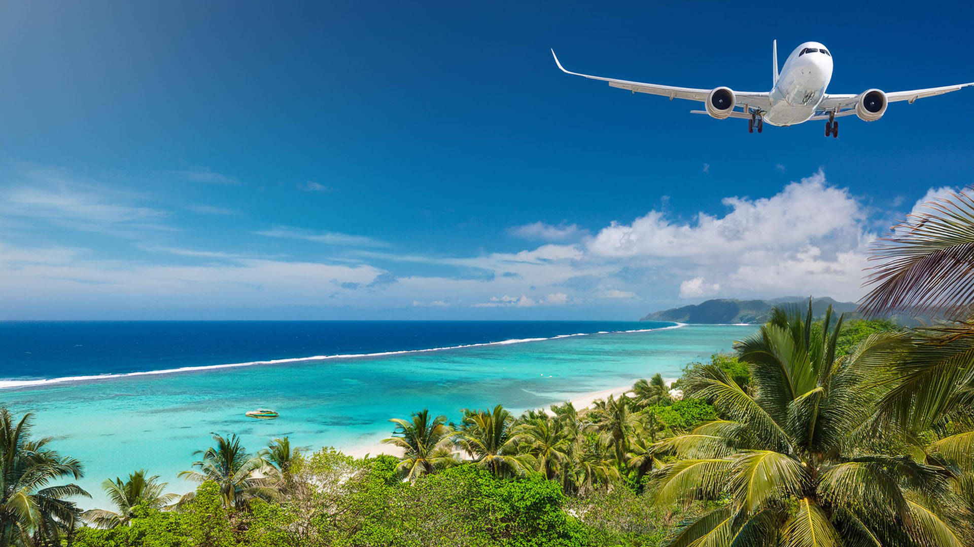 an airplane flying over a tropical paradise