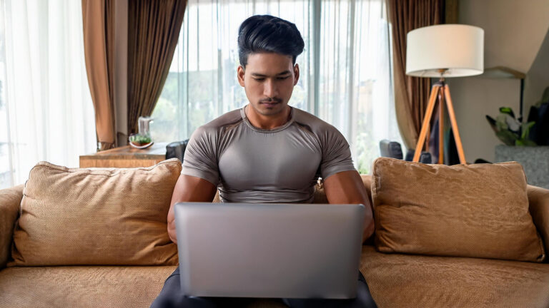 an athletic remote worker at his laptop