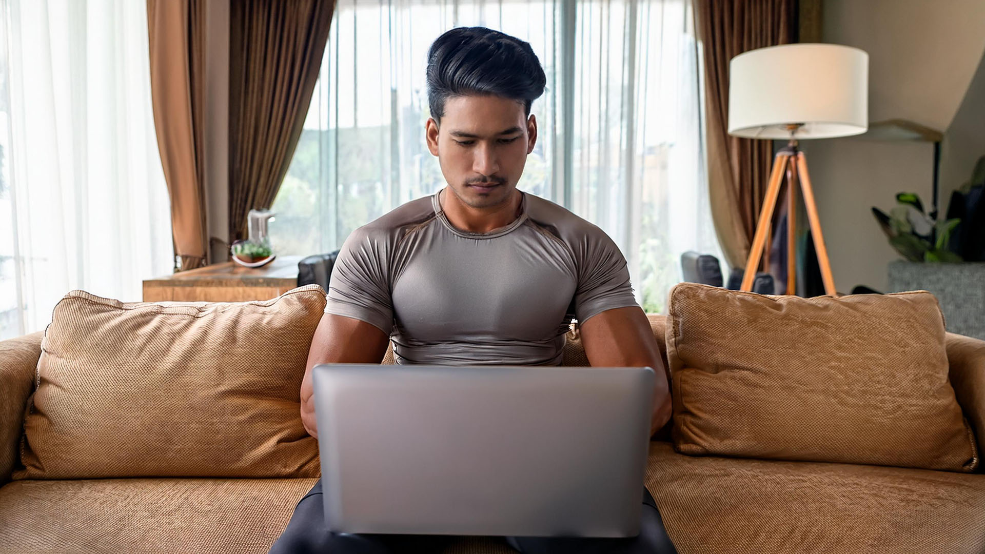 an athletic remote worker at his laptop