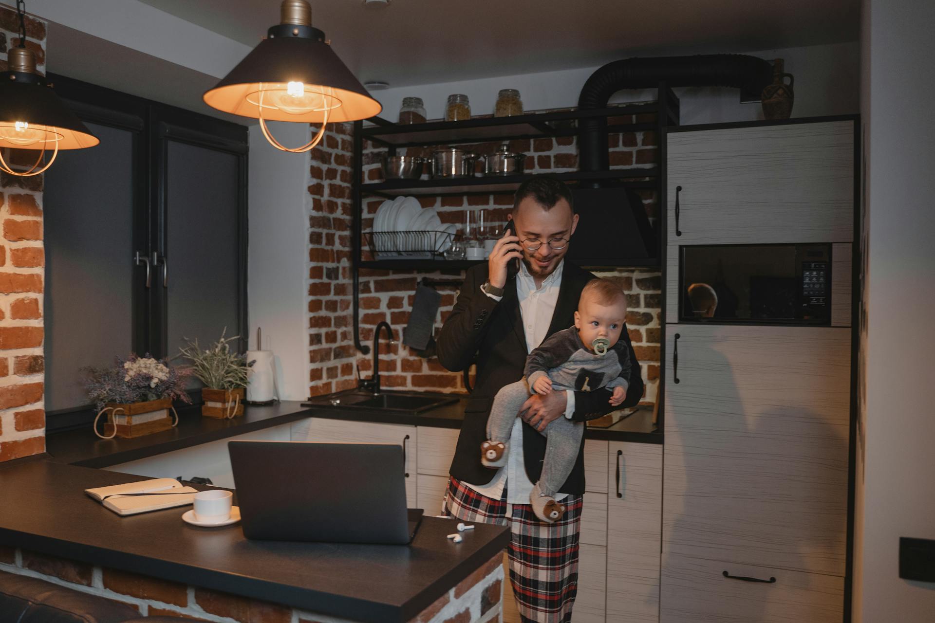 a remote workers trying to take care of his child while working and on the phone