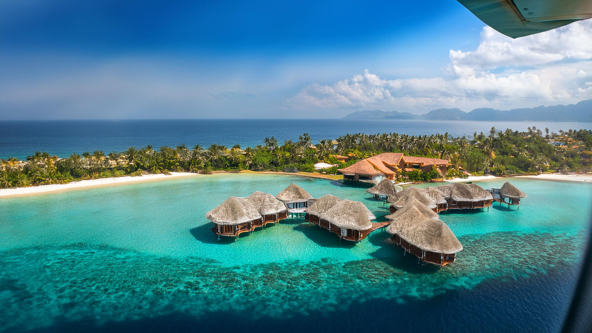 view from an airplane window looking out at a luxurious resort