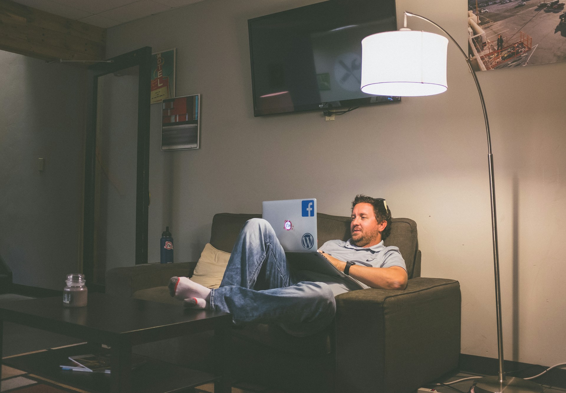 a man working from home on his laptop while sitting on his couch